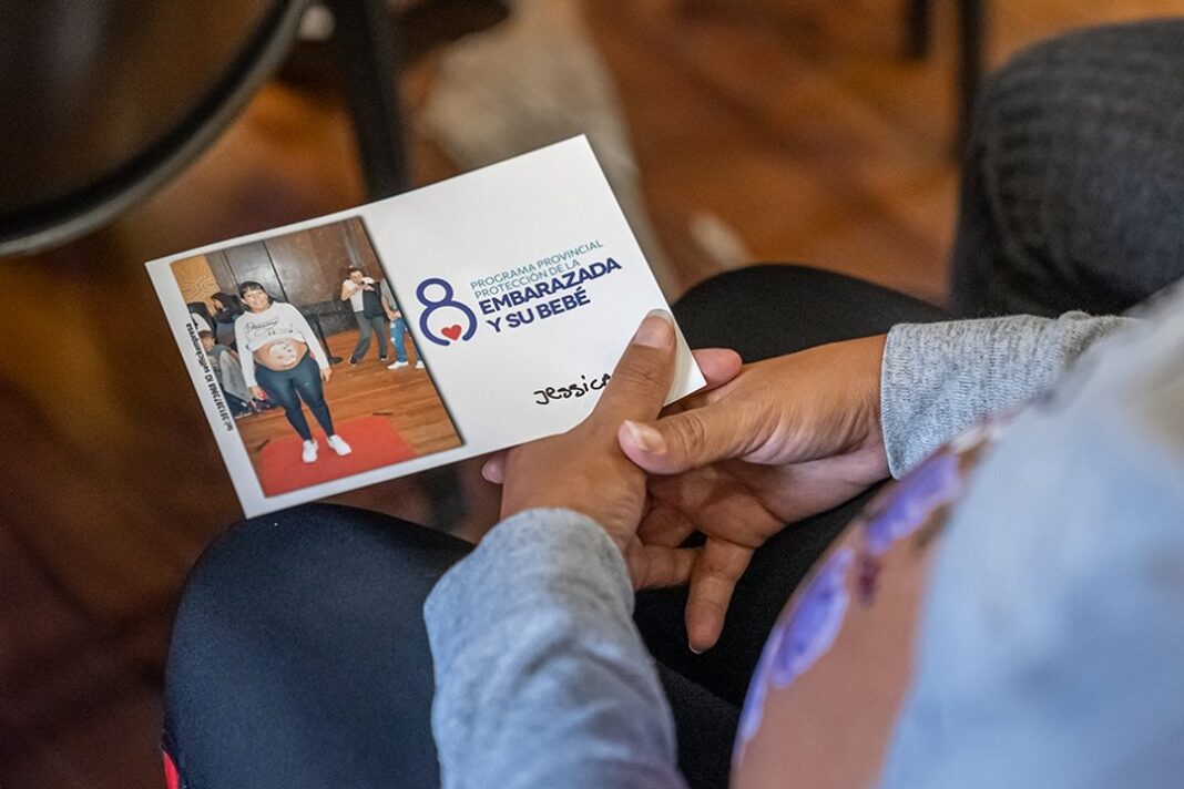 Embarazada sosteniendo su vientre en un consultorio médico